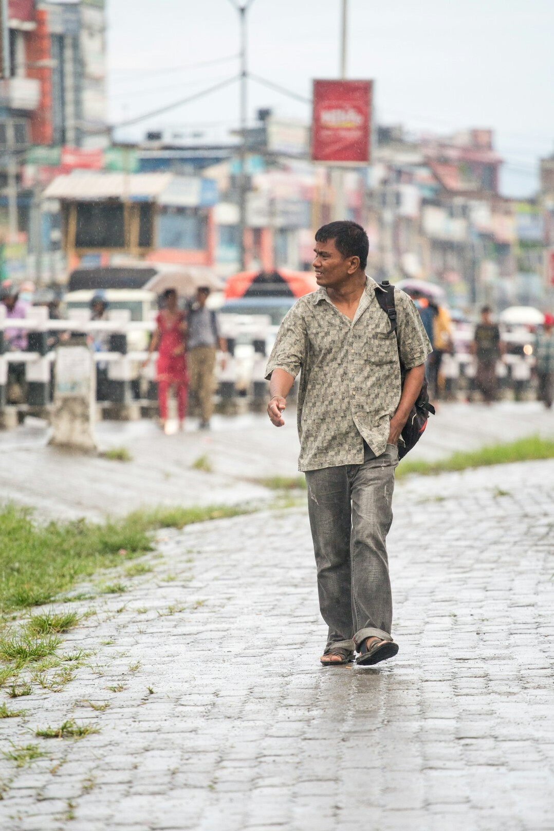 man walking in rain
